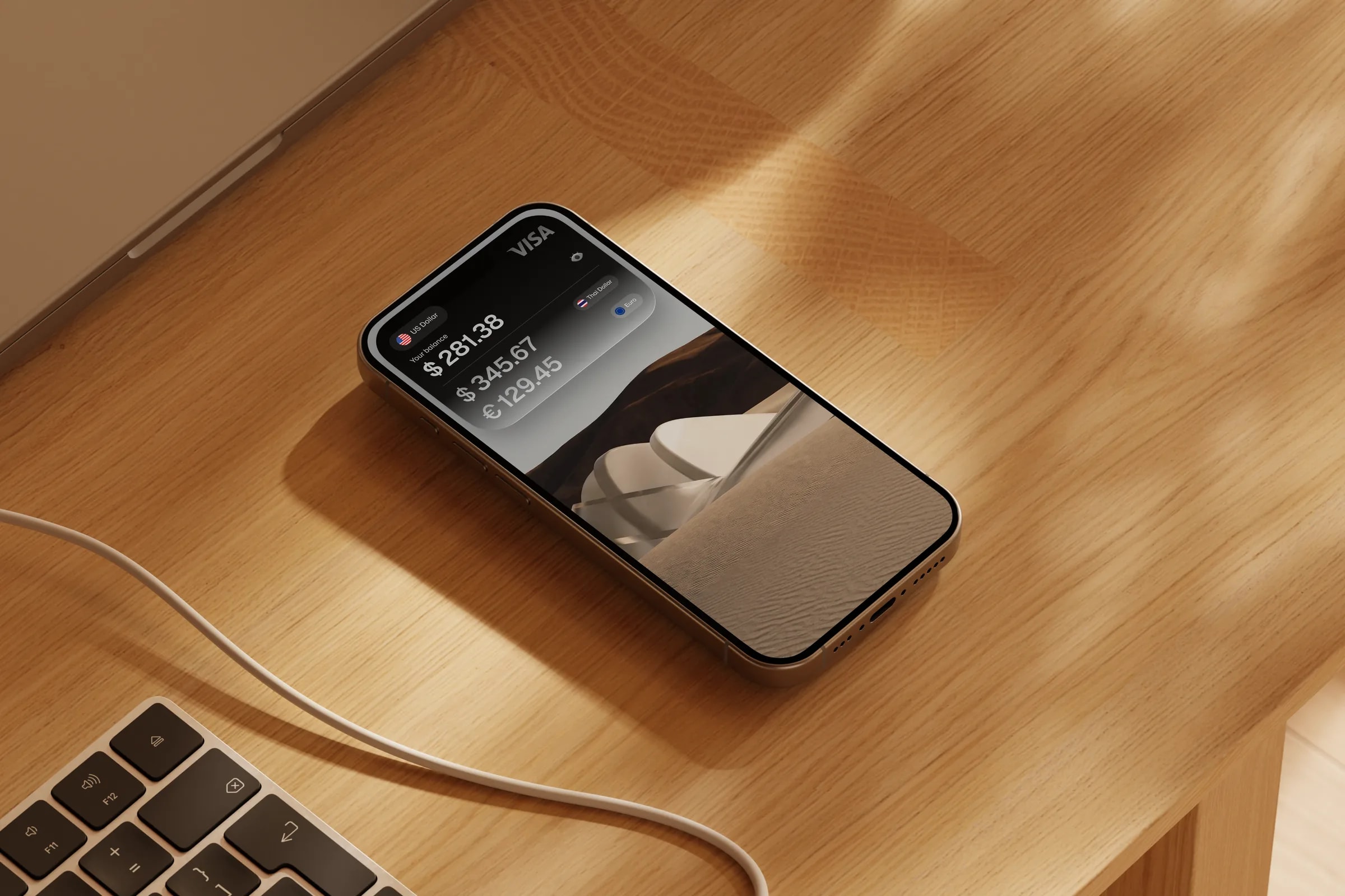 A phone on a desk showing US dollar, euro and pound balances in the Grain app