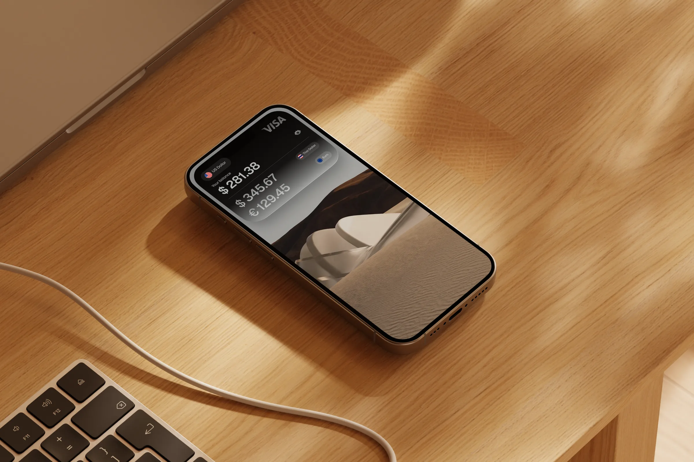 A phone on a desk showing US dollar, euro and pound balances in the Grain app